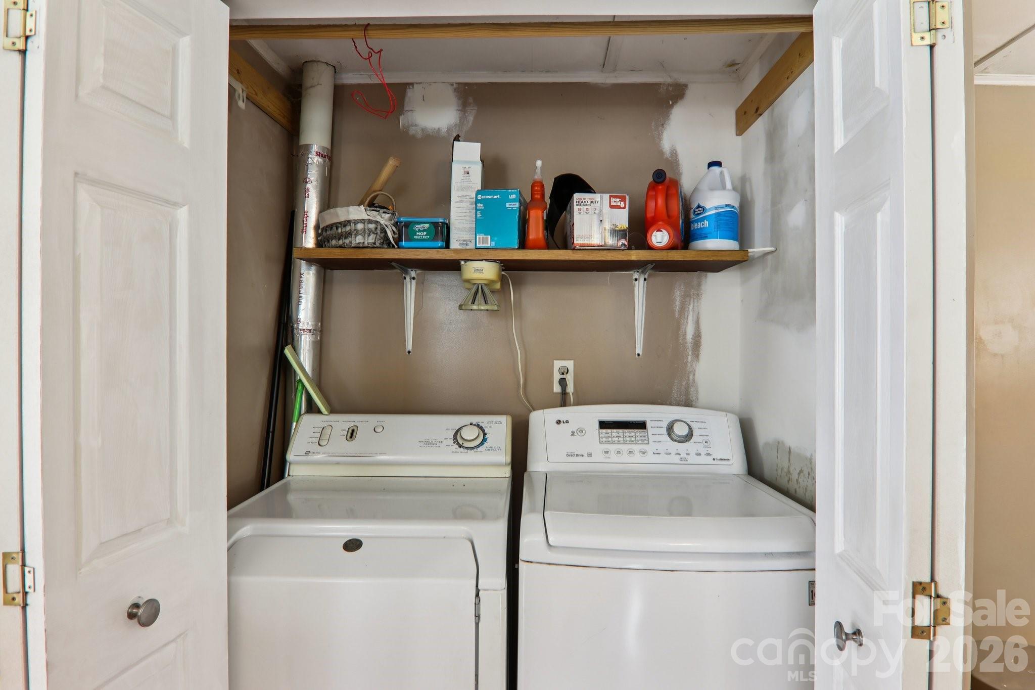 105 Baird Road Mars Hill, NC 28754 - Photo 34 of 48 a utility room with dryer washer and a view of living room