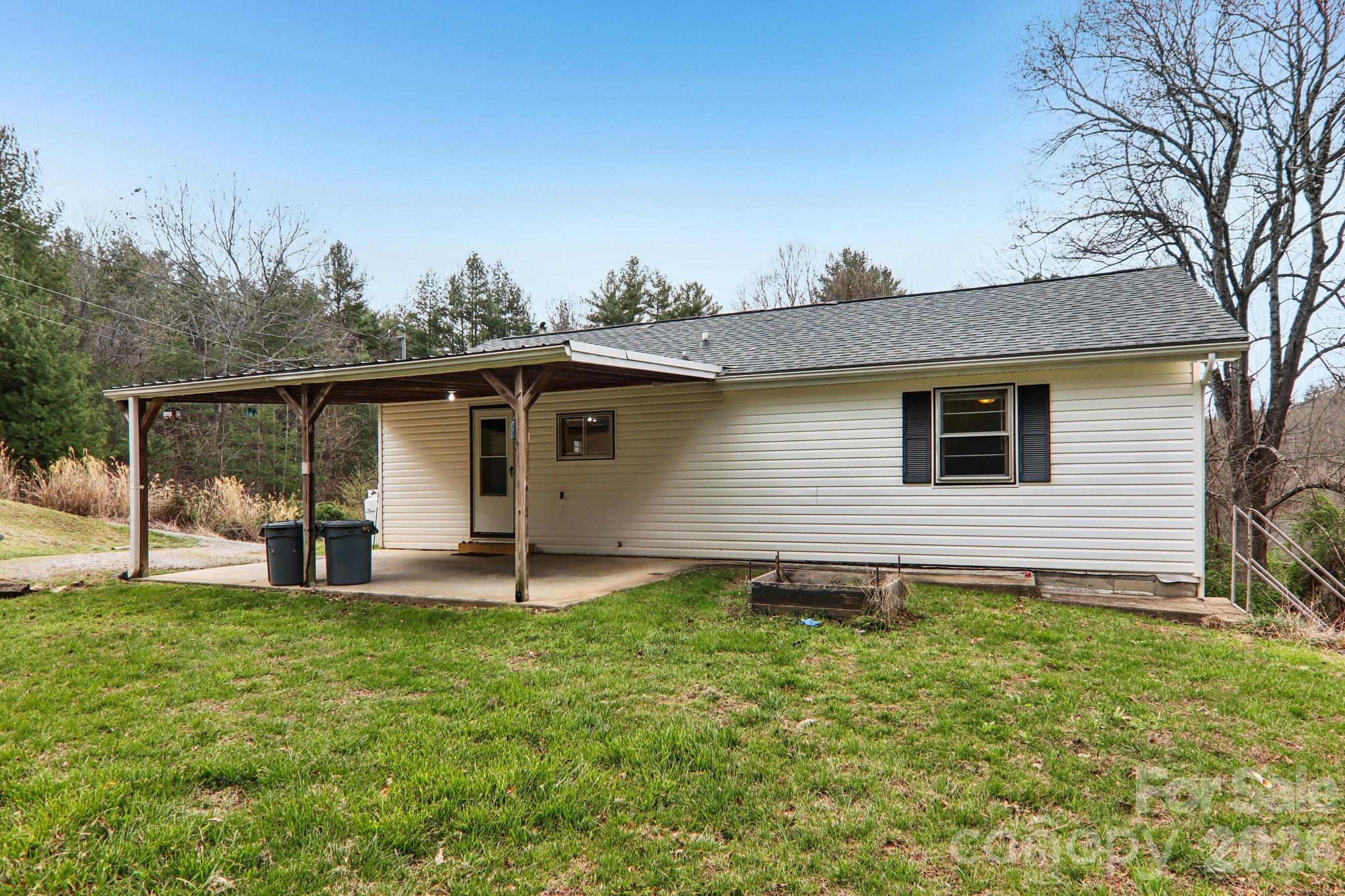 105 Baird Road Mars Hill, NC 28754 - Photo 45 of 48 a backyard of a house with table and chairs