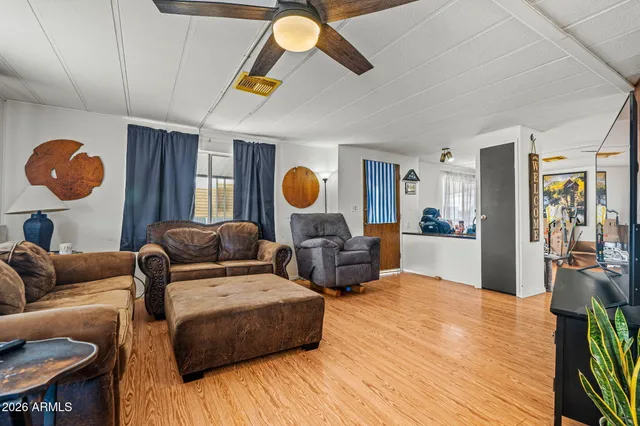 a living room with furniture and wooden floor