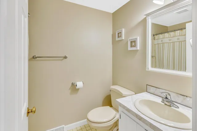 a white toilet sitting next to a bathroom sink