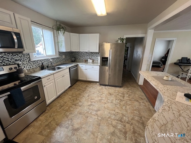 16 Byron Street Waterbury, CT 06704 - Photo 6 of 6 a kitchen with a sink stove and refrigerator