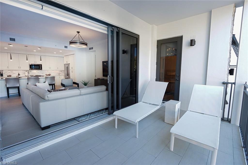 1030 3rd Avenue South, Unit 318 Naples, FL 34102 - Photo 22 of 26 a living room with furniture and kitchen view