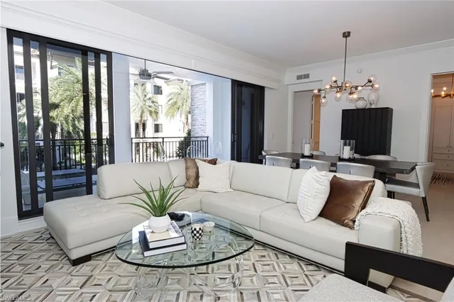 a living room with furniture fireplace and a large window