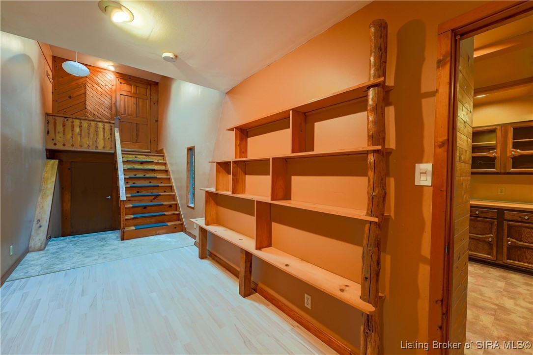 531 Spickert Knob Road New Albany, IN 47150 - Photo 24 of 39 Family room with built in bookshelves and staircas