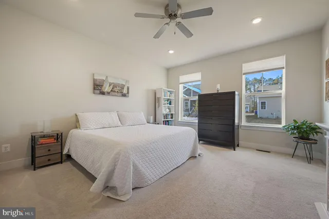 a spacious bedroom with a bed and a chandelier