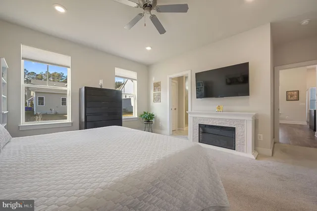 a bedroom with furniture fireplace and a flat screen tv
