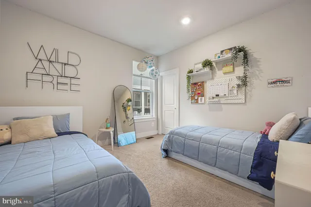 a bedroom with a bed and a chair