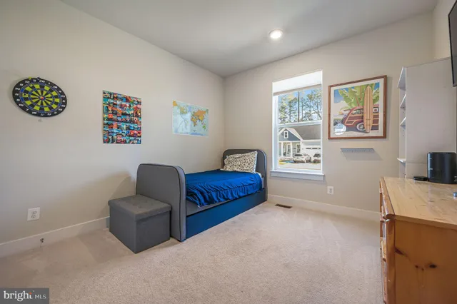 a bedroom with furniture and a window