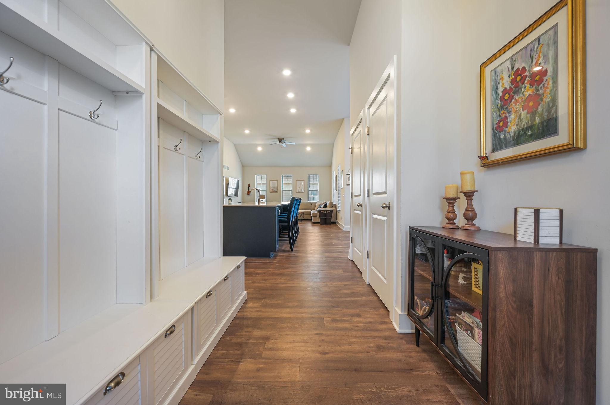 18556 Emerson Way Georgetown, DE 19947 - Photo 3 of 30 a view of a hallway with wooden floor and staircase