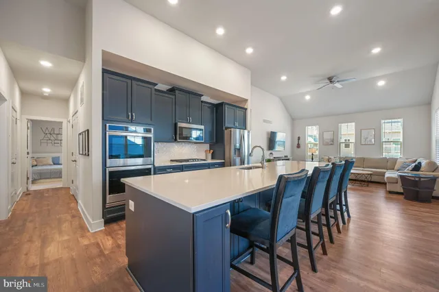 a large kitchen with a table and chairs