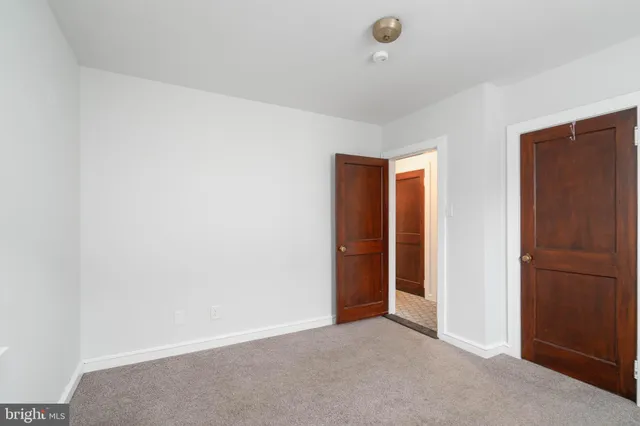 an empty room with closet area