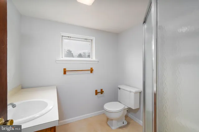 a white toilet sitting next to a bathroom sink and tub