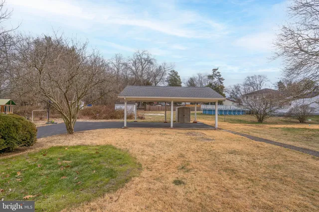 a view of a house with swimming pool and a yard