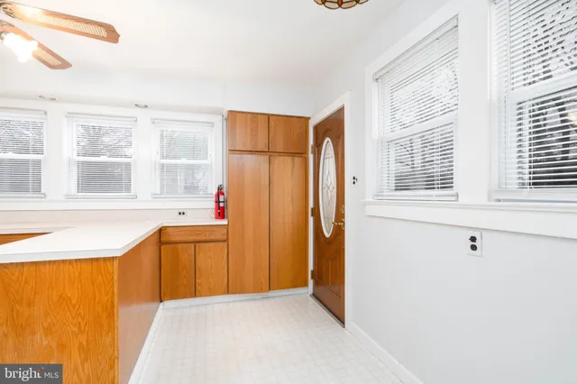 a view of a kitchen with stainless steel appliances wooden cabinets and a window