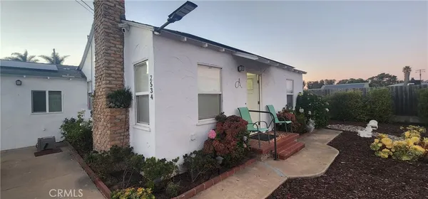 a backyard of a house with outdoor seating