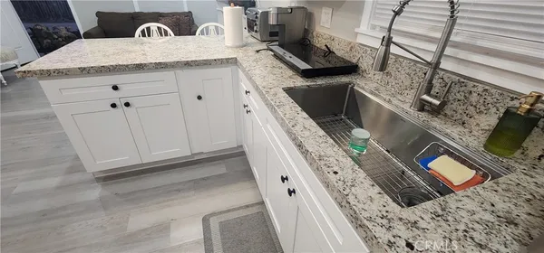 a bathroom with a granite countertop sink a mirror and vanity
