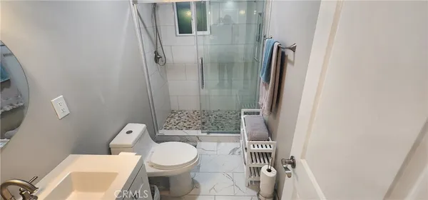 a white toilet sitting next to a bathroom sink