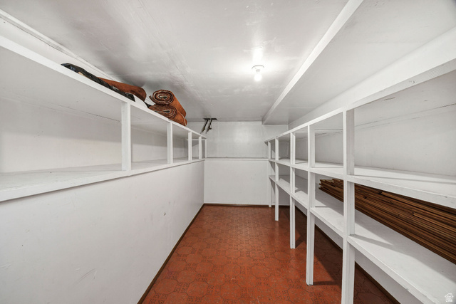 1365 Sumac Drive Logan, UT 84321 - Photo 43 of 66 Dedicated storage room featuring extensive built-in shelving, durable floor tile, and overhead lighting