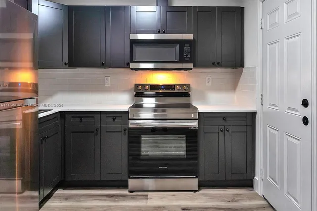 a kitchen with granite countertop a stove and a sink with granite countertops