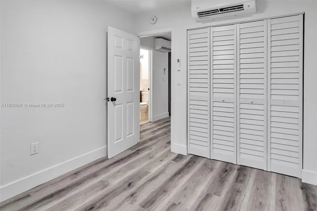 a view of a room with wooden floor and white walls