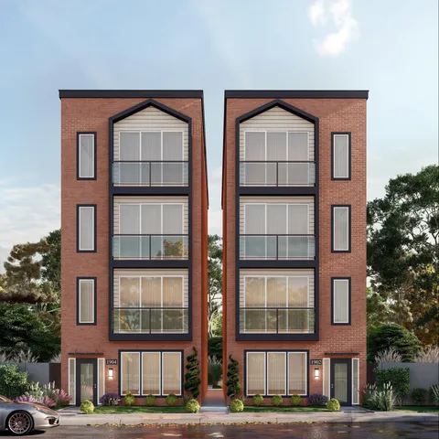 a front view of a residential apartment building with a yard