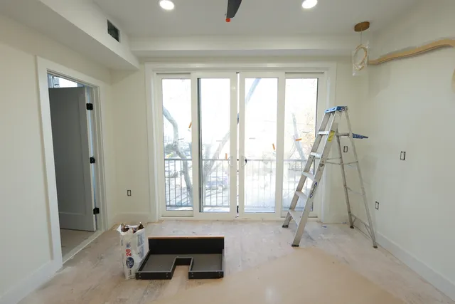 a spacious bedroom with a bed and a window