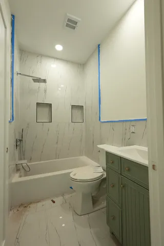 a bathroom with a sink toilet and shower