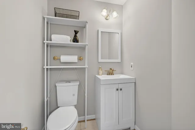 a bedroom with a bed dresser and wooden floor