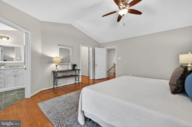 a spacious bathroom with a double vanity sink a mirror and a bathtub