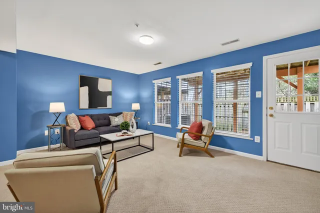 a view of a livingroom with furniture and workspace