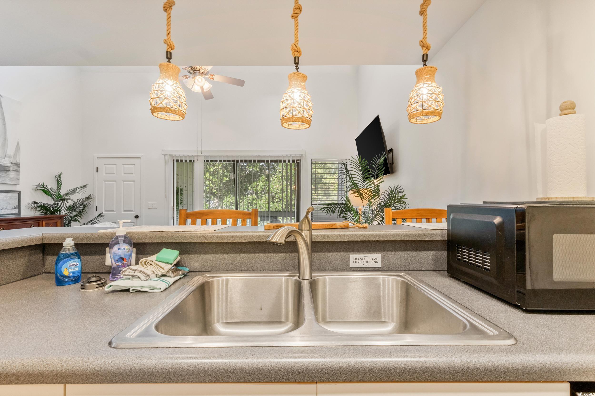 4506 Little River Inn Lane Little River, SC 29566 - Photo 25 of 34 Kitchen featuring light countertops, pendant lighting, and a ceiling fan
