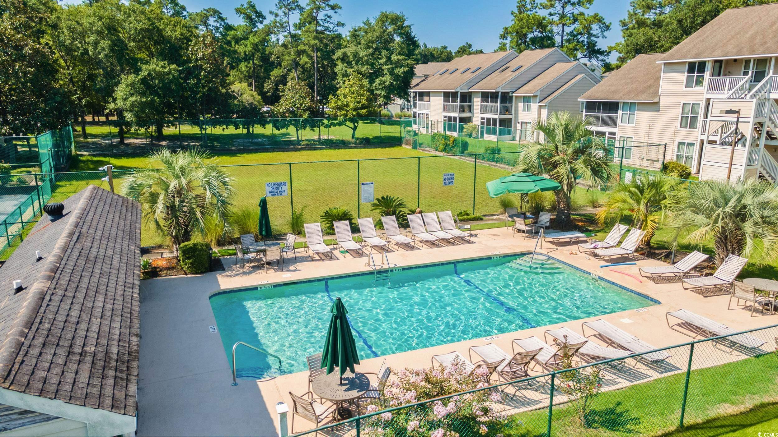 4506 Little River Inn Lane Little River, SC 29566 - Photo 3 of 34 Community pool featuring a patio