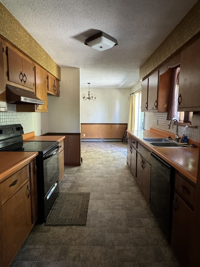 3222 250 East Road Herscher, IL 60941 - Photo 8 of 31 a kitchen with stainless steel appliances granite countertop a stove a sink and a microwave