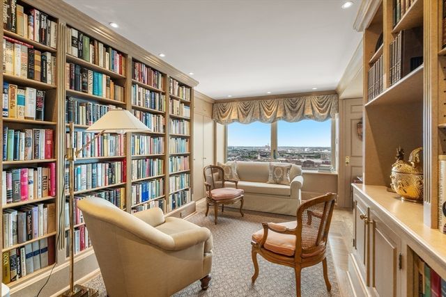 a living room with furniture and a book shelf