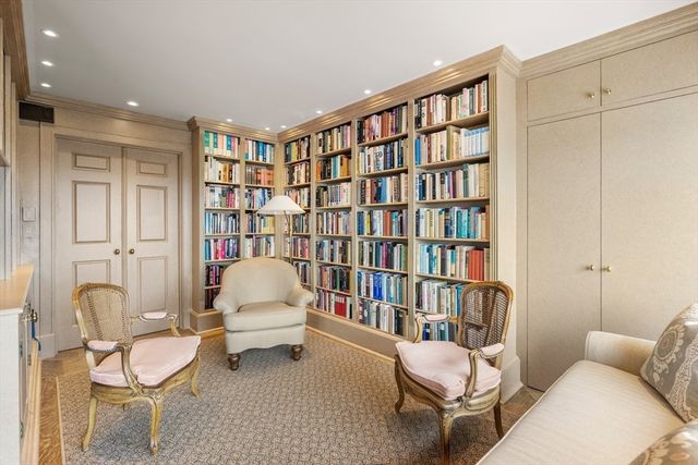 a bedroom with furniture and a book shelf