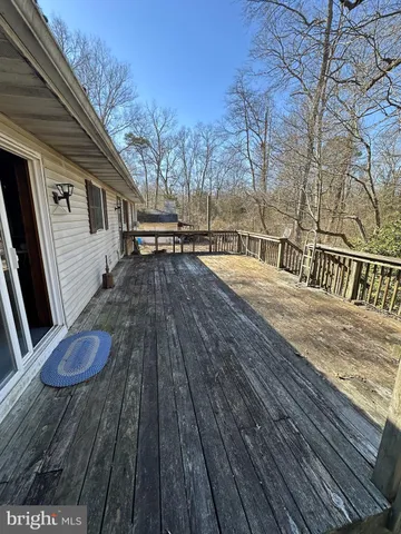 a kitchen with stainless steel appliances granite countertop a stove a sink dishwasher and a refrigerator with wooden floor