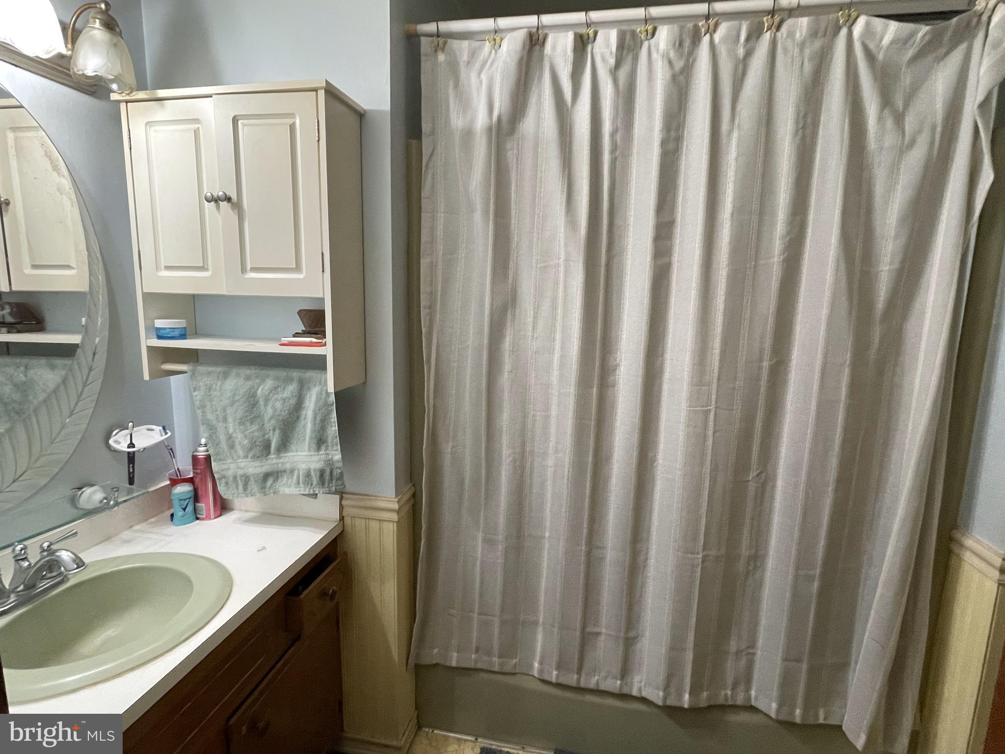 14706 Cherry Lane Ridgely, MD 21660 - Photo 4 of 17 a bathroom with a granite countertop sink and a mirror