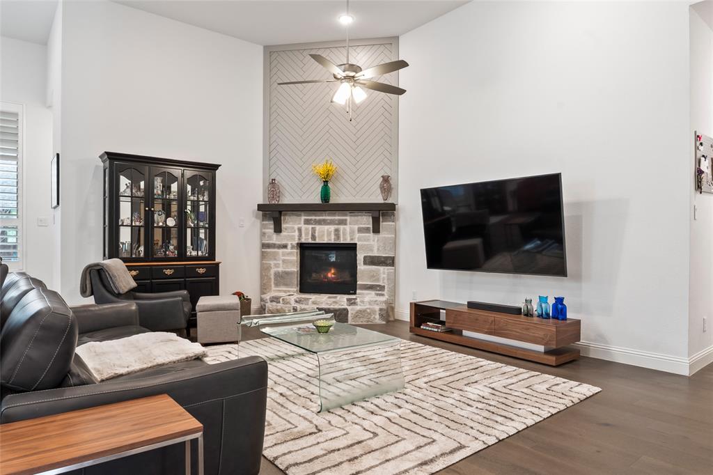 2109 Georgetown Boulevard Prosper, TX 75078 - Photo 12 of 40 a living room with furniture a flat screen tv and a fireplace