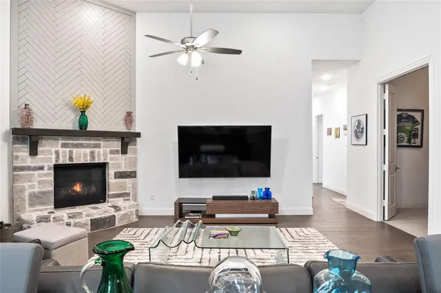 a living room with furniture a fireplace and a flat screen tv