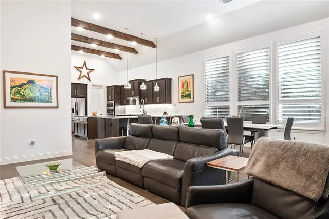 a living room with furniture and large windows
