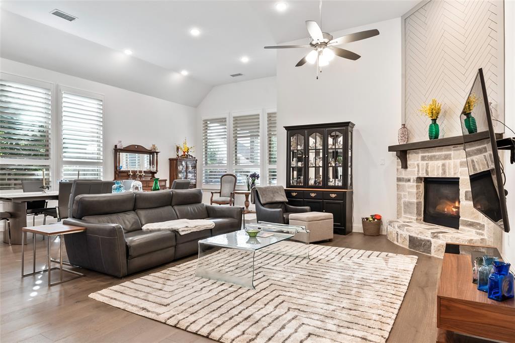 2109 Georgetown Boulevard Prosper, TX 75078 - Photo 17 of 40 a living room with furniture ceiling fan and a fireplace