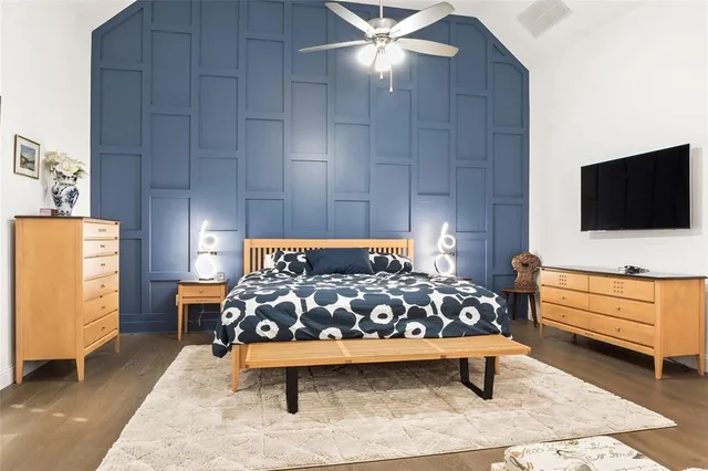 a bed room with furniture and a flat screen tv