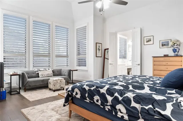 a bedroom with a bed couch and a dresser