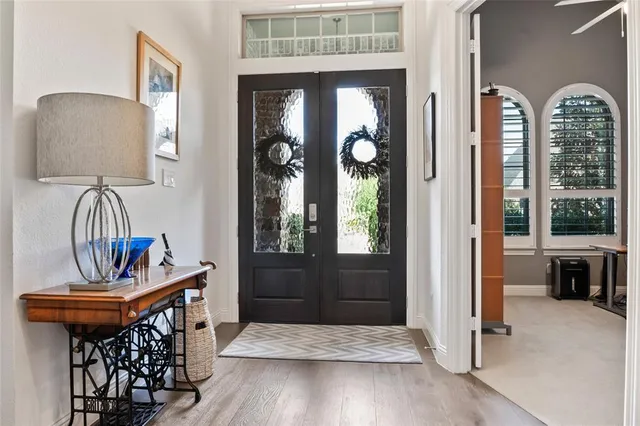 a view of hall way with furniture and a window