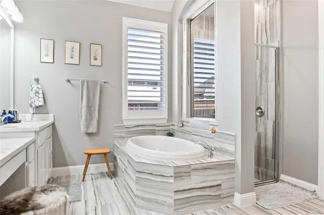 a spacious bathroom with sink and a bathtub