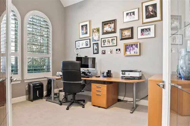 a view of a workspace with furniture and a window