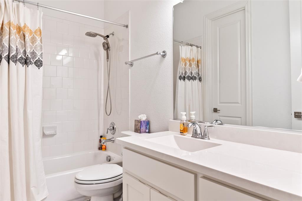 2109 Georgetown Boulevard Prosper, TX 75078 - Photo 25 of 40 a bathroom with a sink a toilet and shower