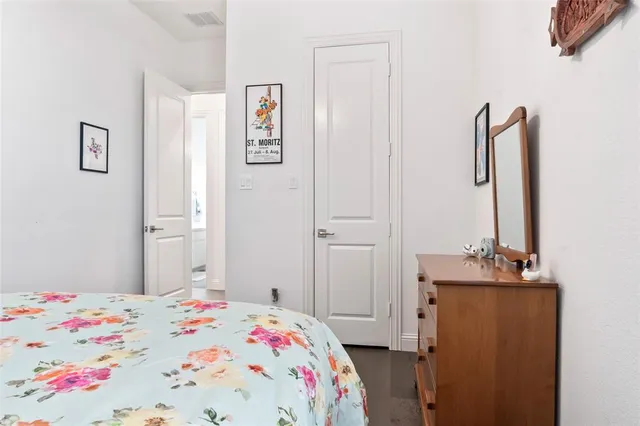 a bedroom with a bed and a dresser