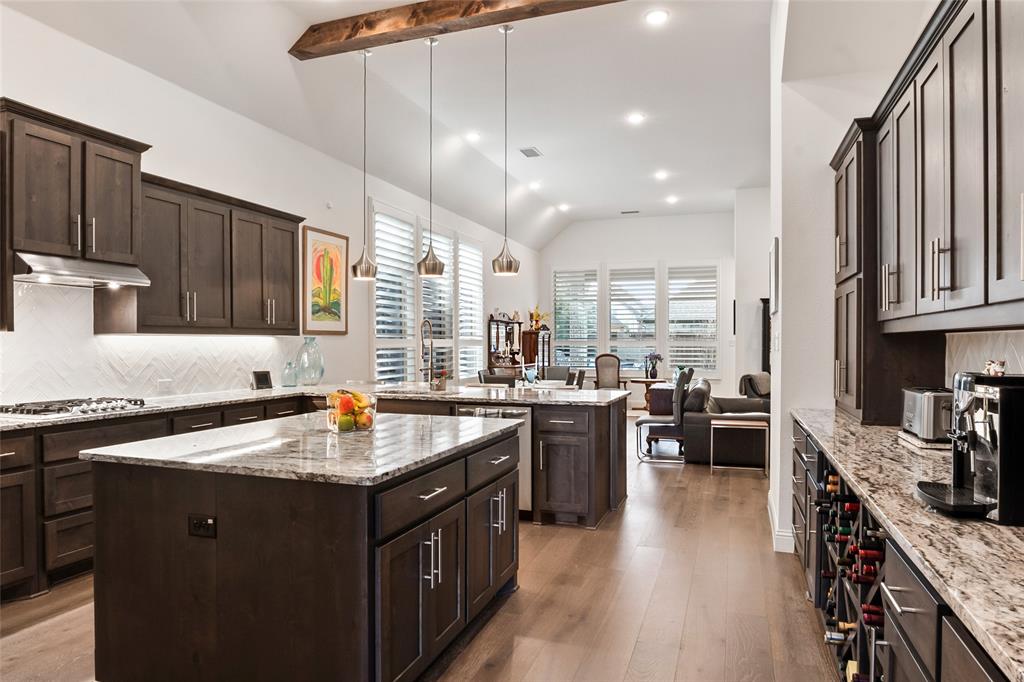 2109 Georgetown Boulevard Prosper, TX 75078 - Photo 3 of 40 a kitchen with lots of counter top space a sink appliances and cabinets