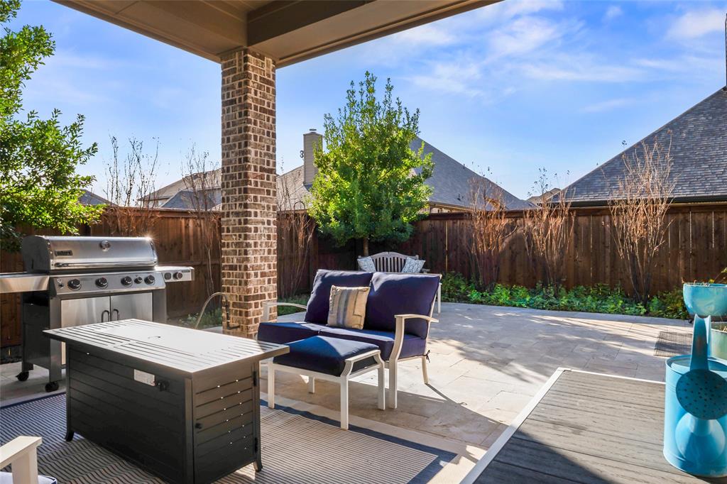 2109 Georgetown Boulevard Prosper, TX 75078 - Photo 37 of 40 a view of a patio with table and chairs with wooden fence and plants